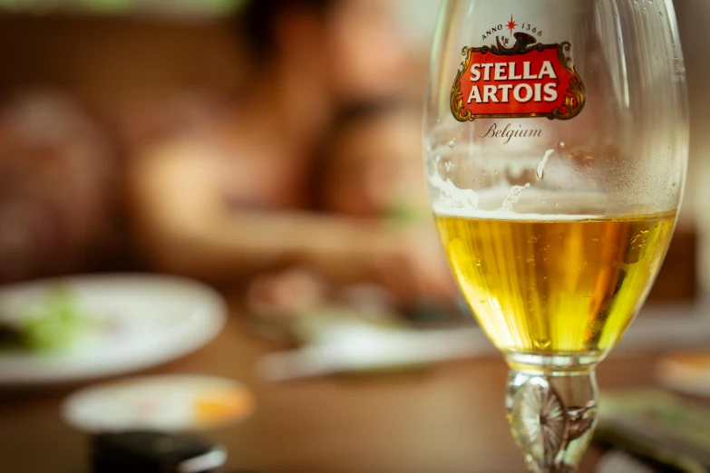 closeup of a glass of beer sitting on a table