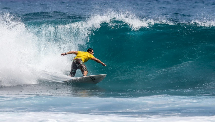 a man on a surfboard in the middle of a wave