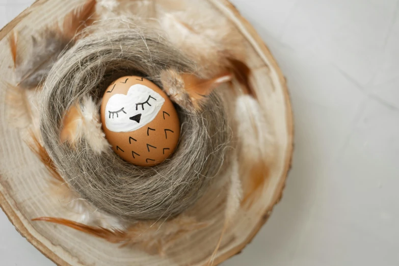 a egg with painted eyes and eyelashes on it