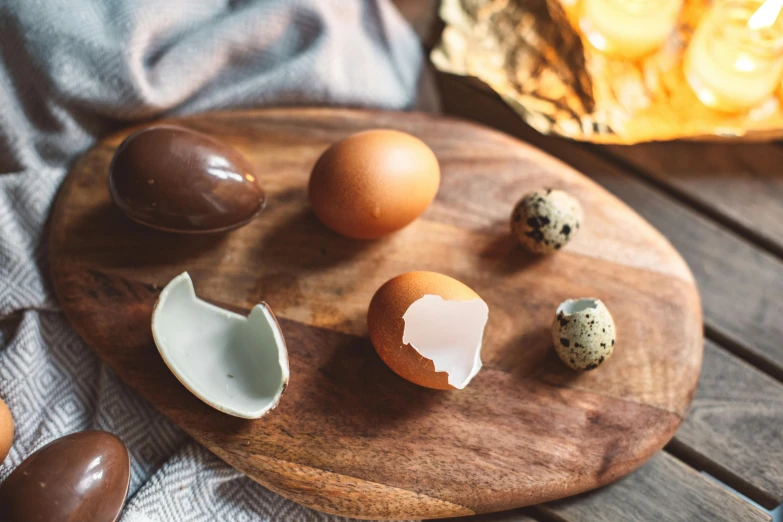 eggshells on a wood board with eggs on the plate