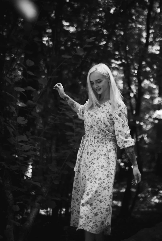 a girl with long blonde hair in floral dress