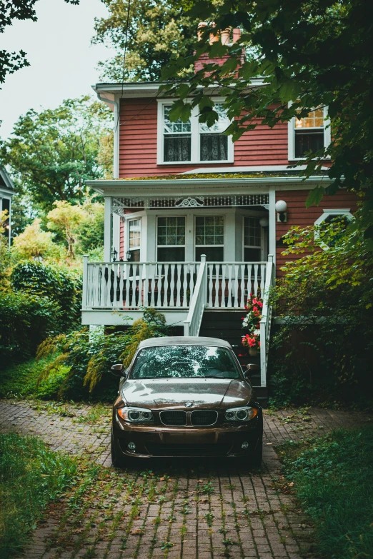 a car parked in front of a house with a porch