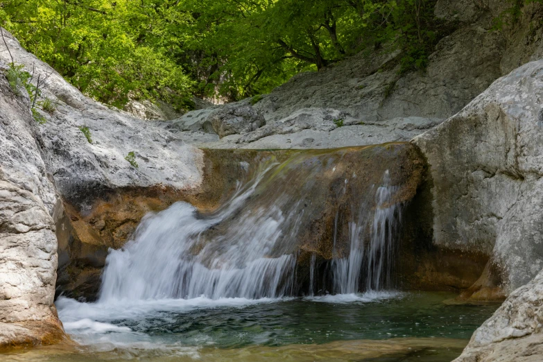 a small waterfall flowing down to a lake