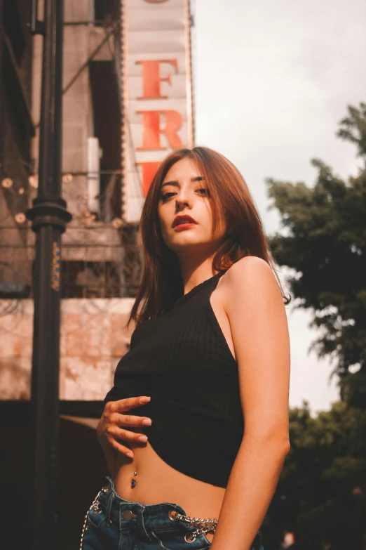 a women standing near a pole in a city