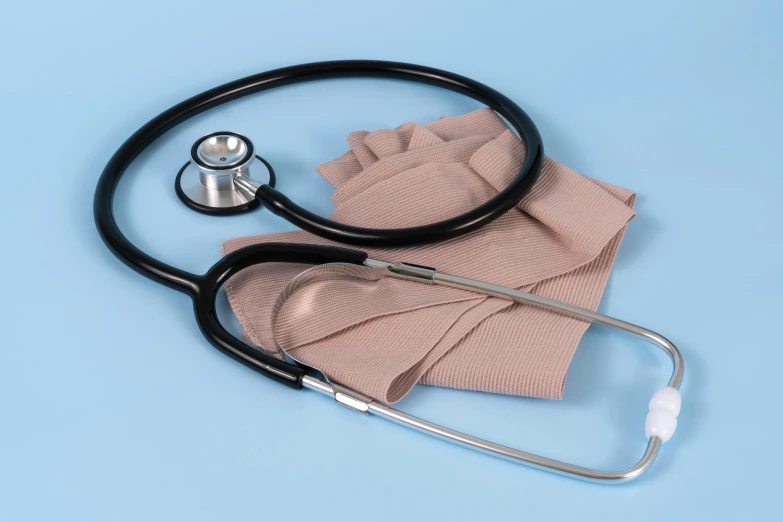 a stethoscope and cloth are on a blue background