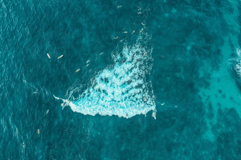 a view from above shows the top end of the water as it flows past a wave