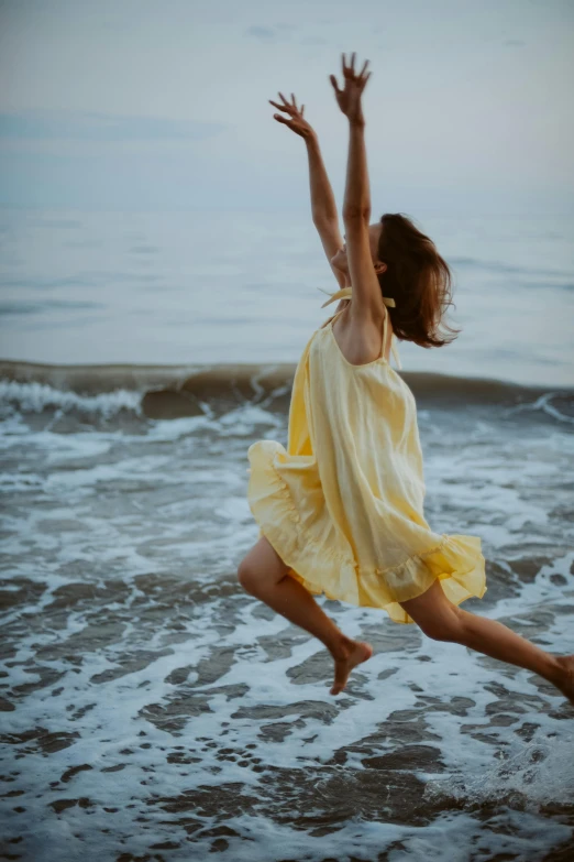 a woman in a dress jumping in the air