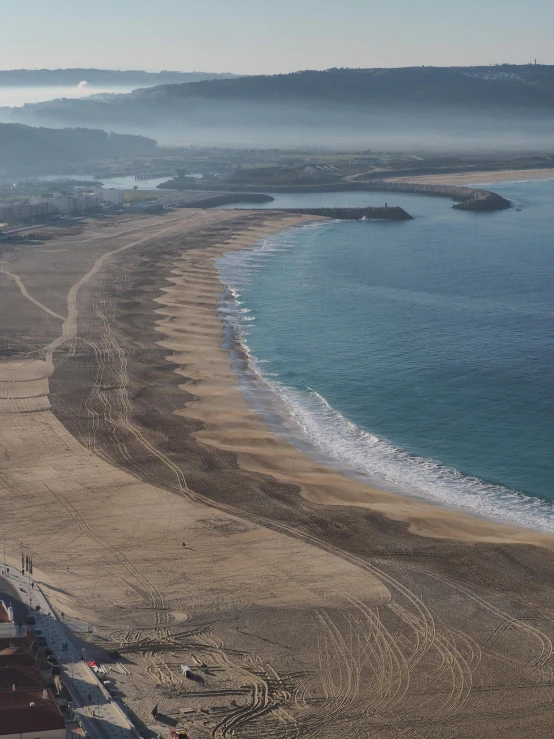 an aerial view of a beach in the middle of the ocean