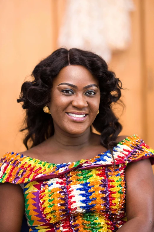 an african american woman wearing a colorful dress