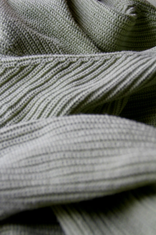 the gray knit material is folded neatly on top