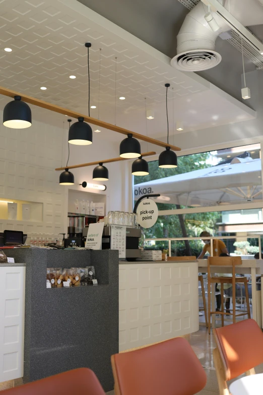 a cafeteria with a desk with a laptop on it and a person in a chair