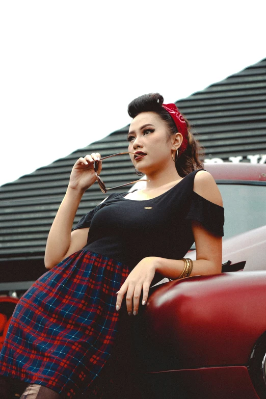 a woman smoking a cigarette next to a car