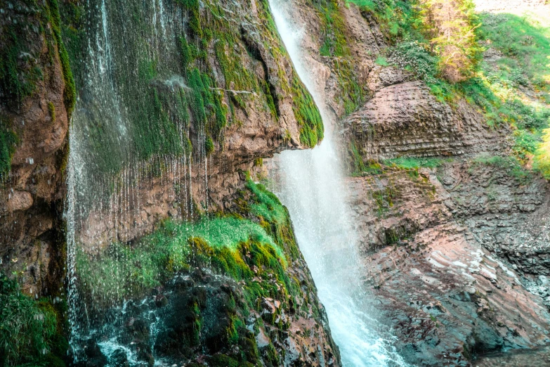 a large waterfall that is cascading over some rocks