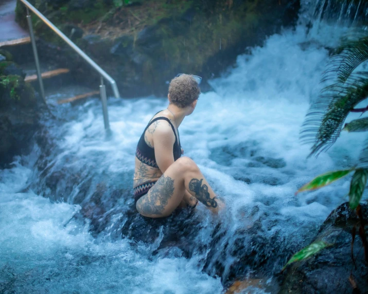 a guy on a small waterfall on some kind of  spring