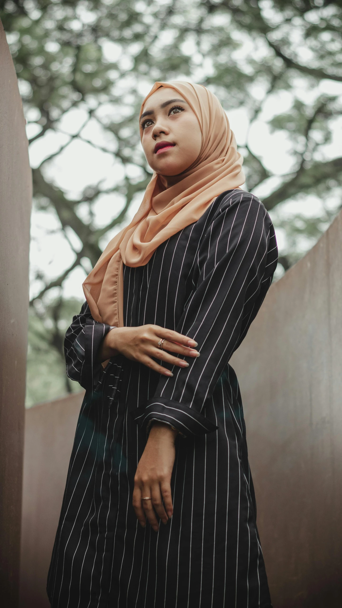 a woman with her arms crossed standing