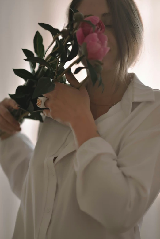 there is a woman holding a bunch of flowers