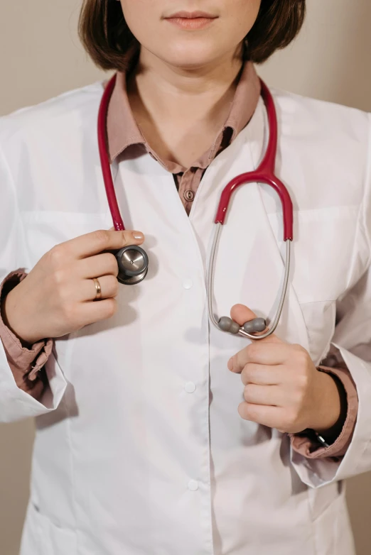 a woman with a red stethoscope around her neck