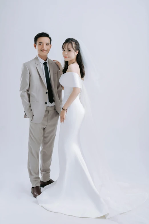 a young couple posing for a pograph in front of a white background