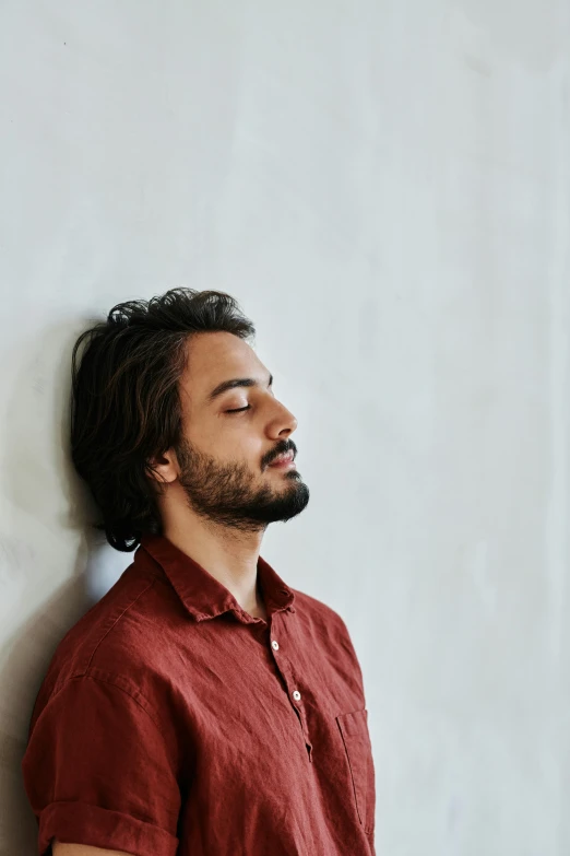 a man is leaning up against a wall