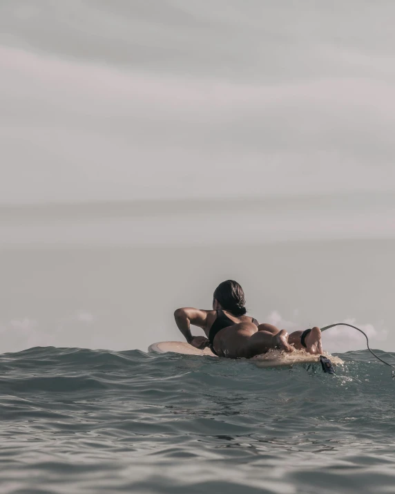 an image of a person swimming on surf board