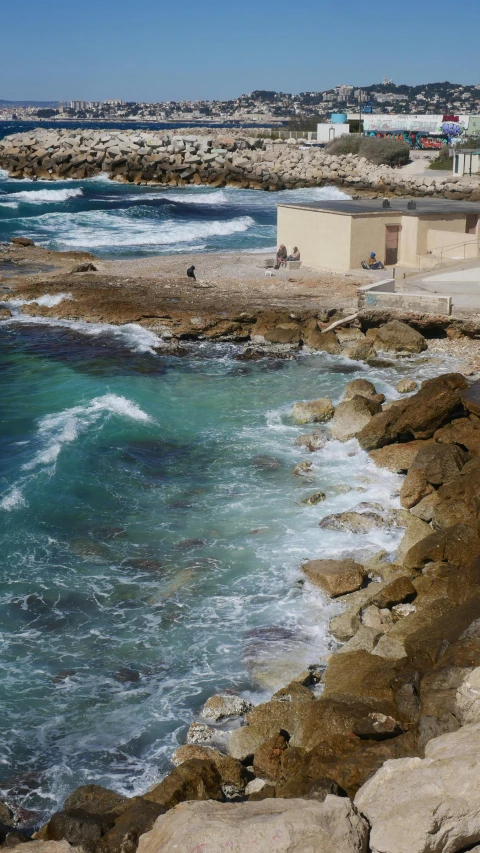 a beach with rocky shoreline and a blue ocean