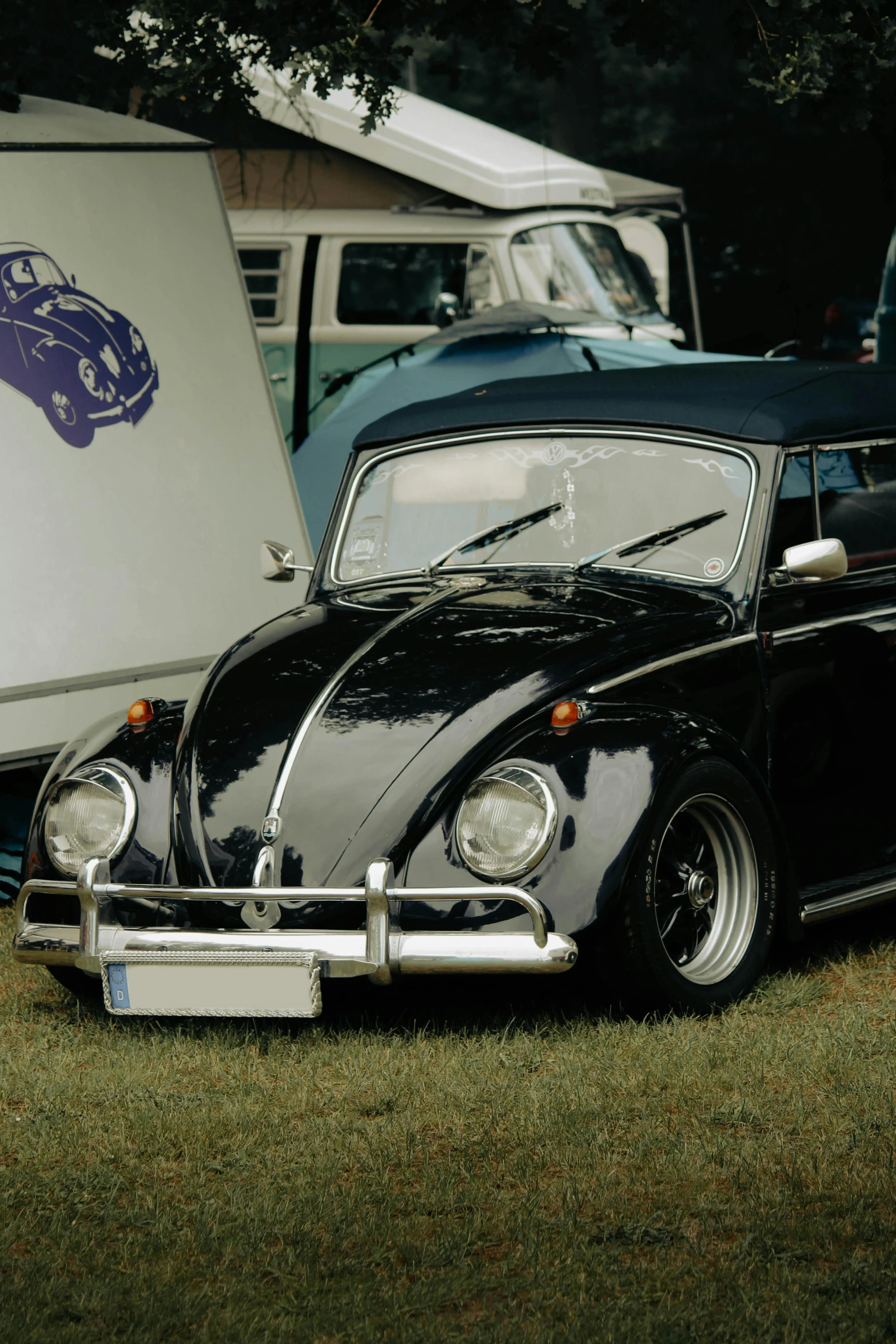 two cars parked side by side on a grassy lot