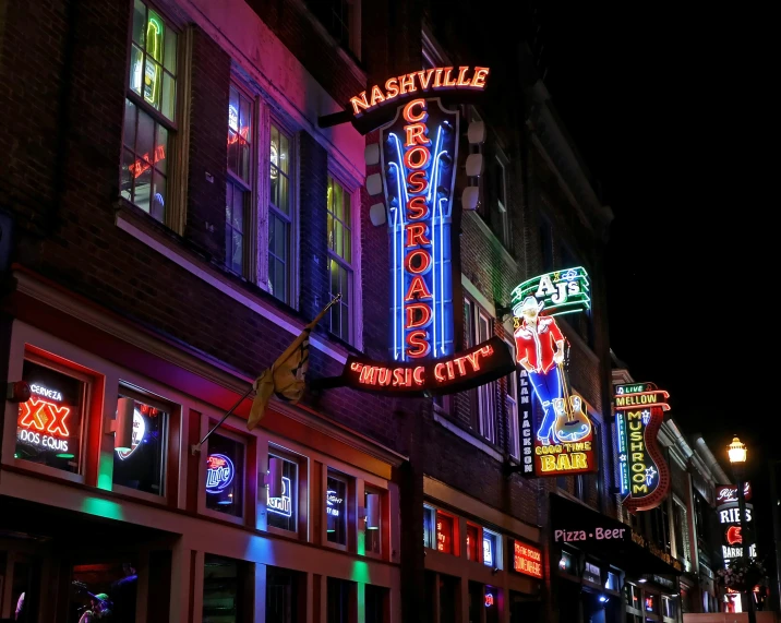 a colorful sign for a music venue in front of a building