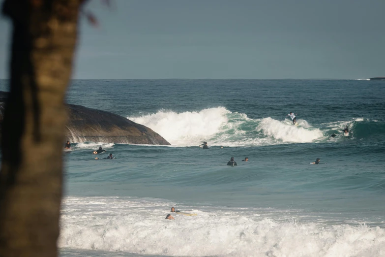 a group of people riding surfboards on top of waves