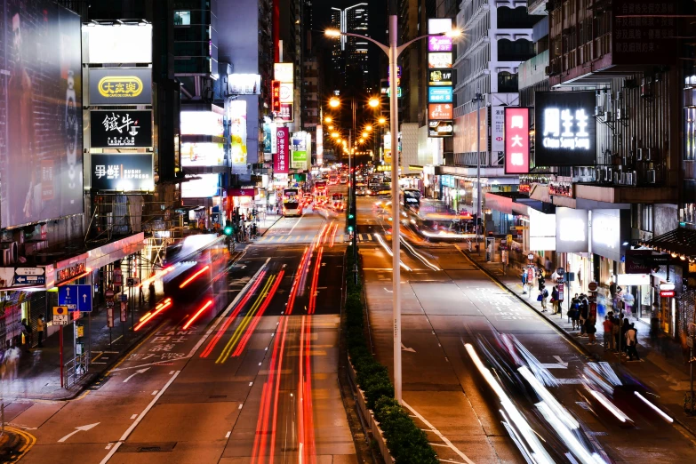 cars travelling on a busy city street at night