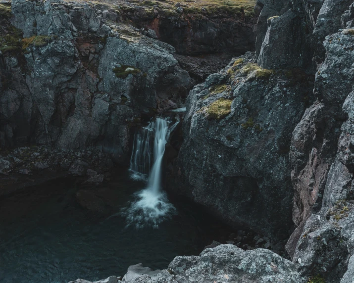 a waterfall in the rocks has water coming out