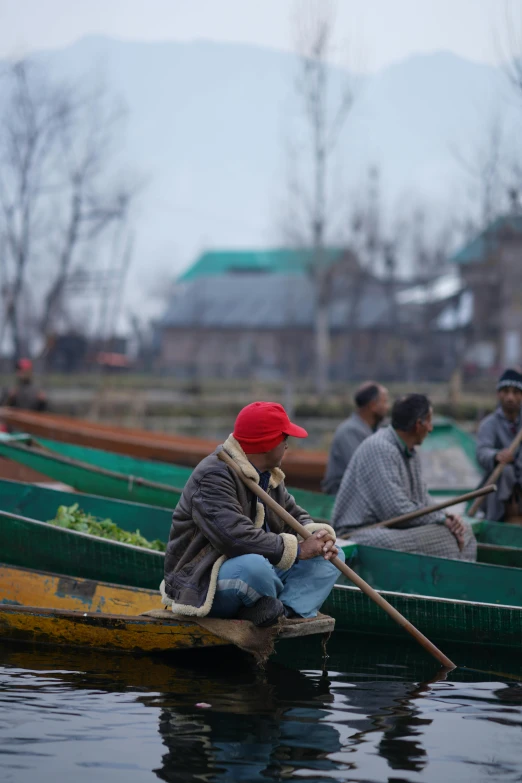 a group of men in a row boat fishing