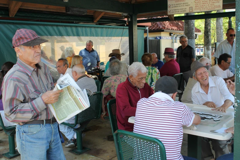 several elderly people sitting at the restaurant eating