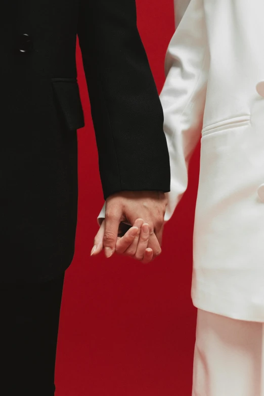 two people hold hands with one another