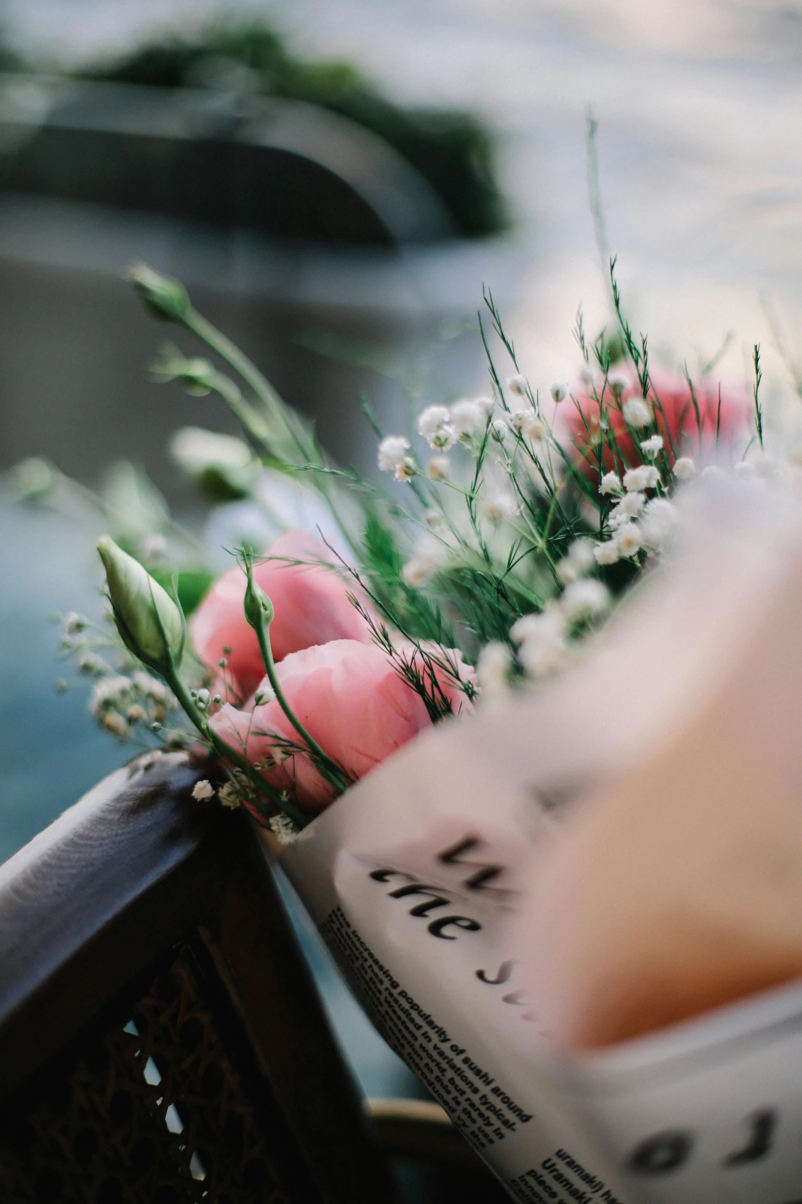 flowers in front of newspaper laying on chair