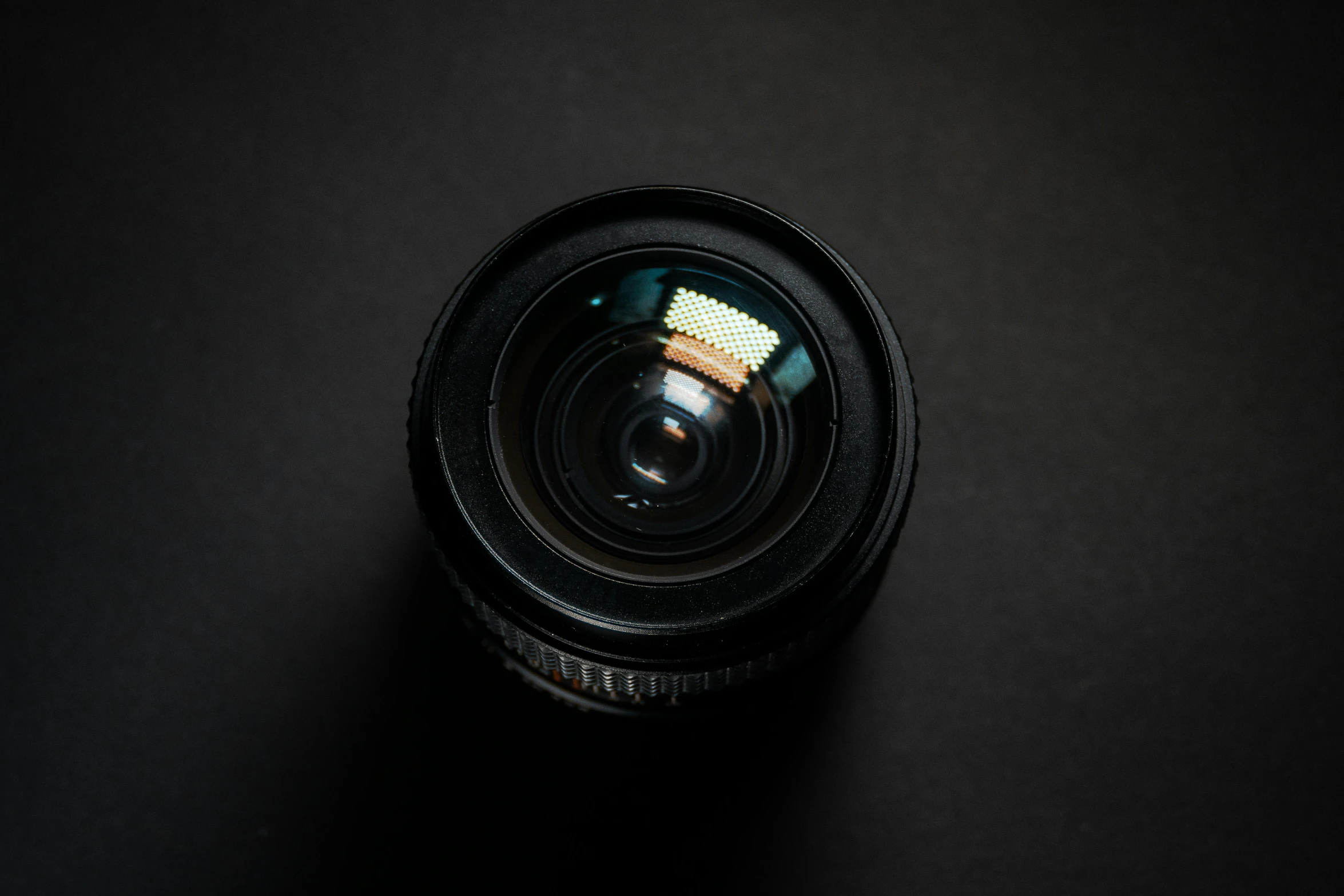 a camera lens is shown on a black surface