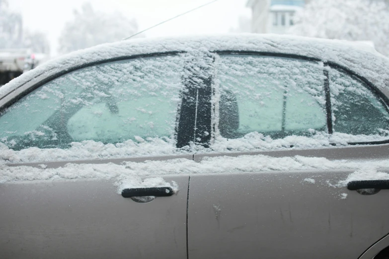 the window and front windows are covered by the snow