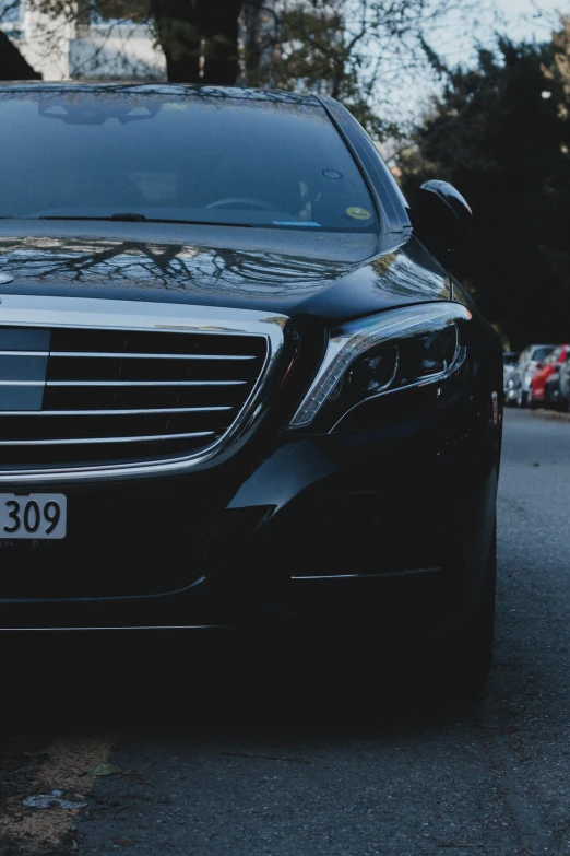 an image of black mercedes parked on the side of the road