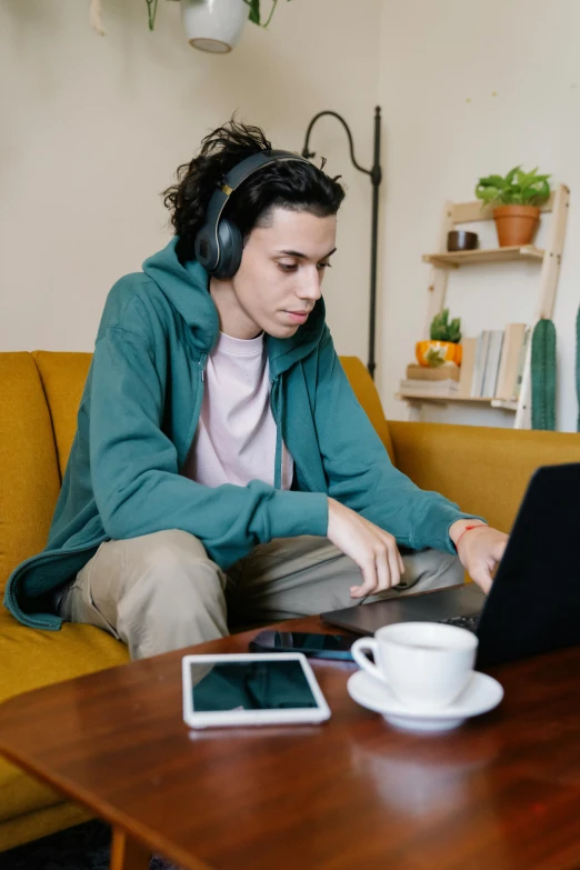 a woman sitting on a couch using a laptop