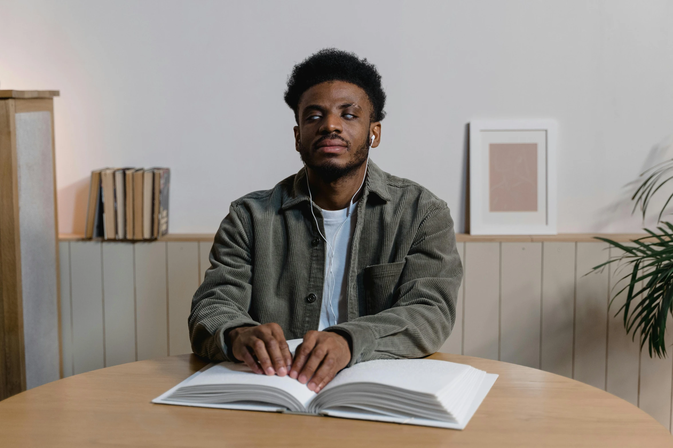 a man sitting at a table with an open book