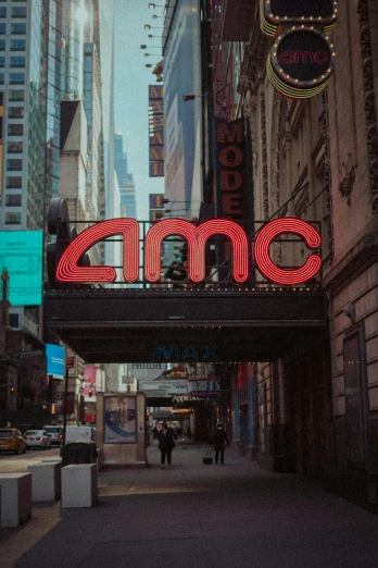 a large sign that reads amc on a city street