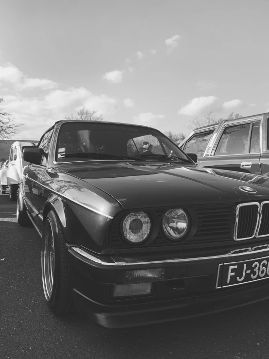 two cars parked side by side with the hood up