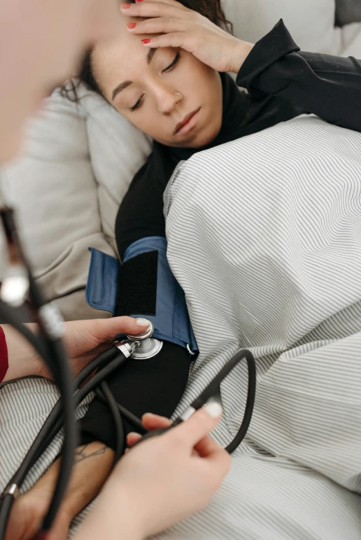 a young female is being examined by a medical nurse