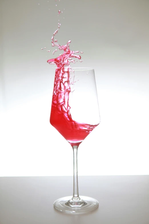 a glass filled with water and liquid on a table