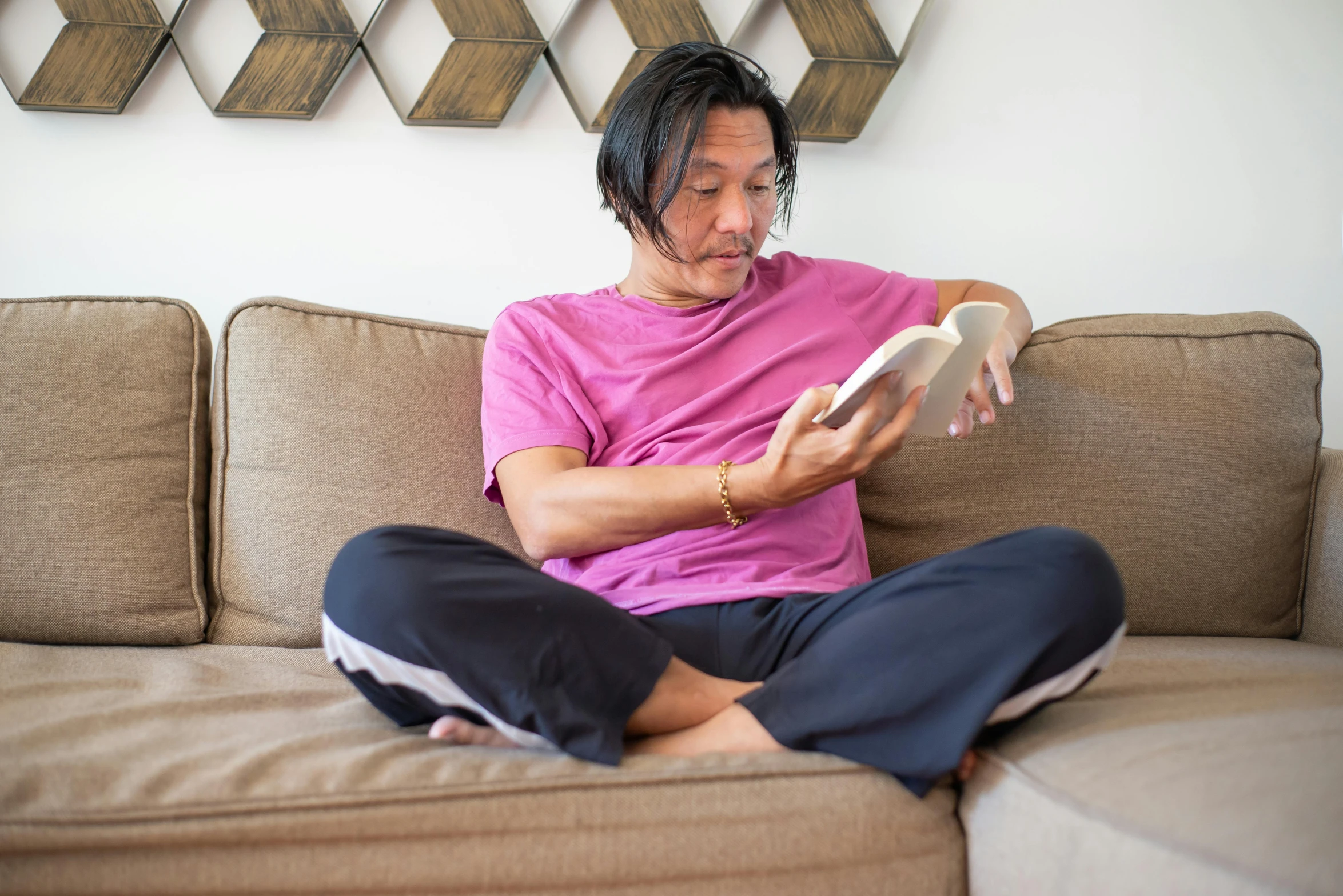 a person is sitting on a couch holding an object