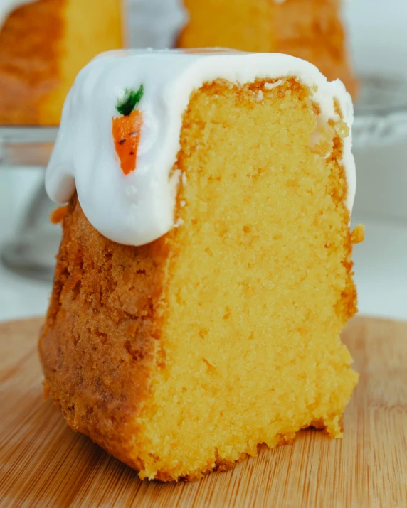 a slice of cake with icing and carrots on top