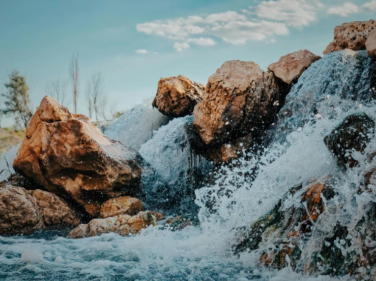 small foamy water gushing out of a stream of water