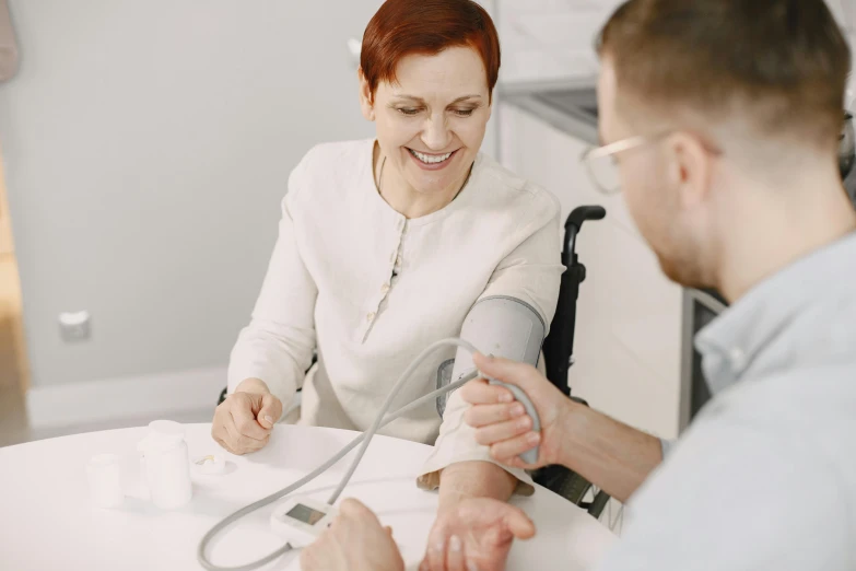 a young woman in her wheelchair holds on to a cord for an iv device