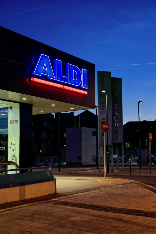 a store is lit up at night, with signage