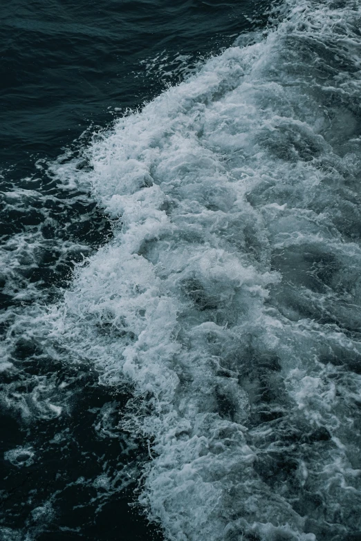 a close up view of the wake of an ocean boat