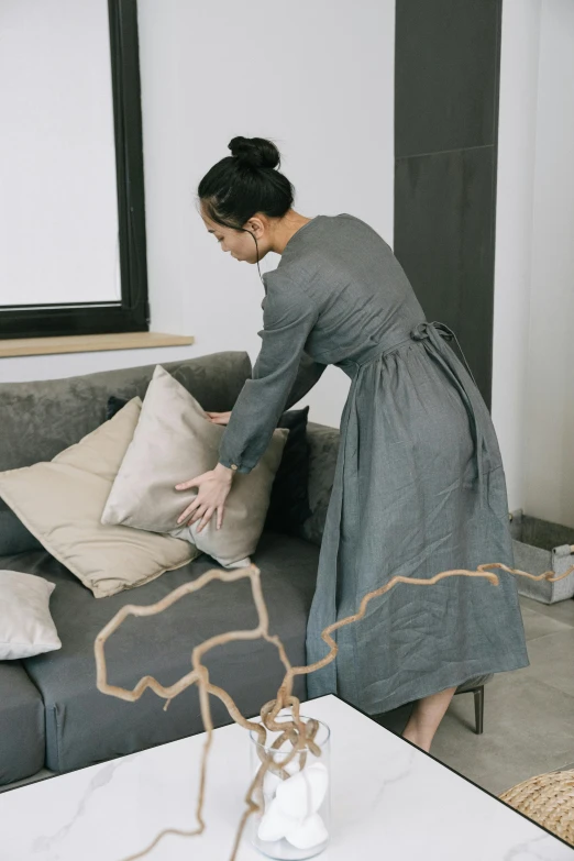 a woman in a dress is playing with some toys